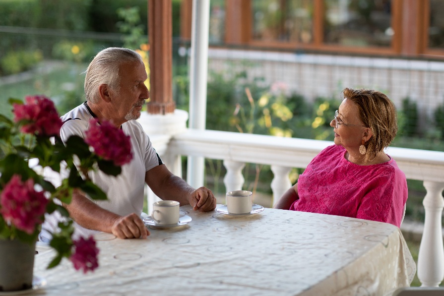 Senior couple discussing care options and drinking tea at home